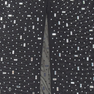 Detail of black mesh fabric with silver rhinestones and sparkling crystal embellishments