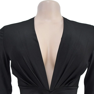 Detail view of women's black V-neck dress featuring gathered waist and wrap front design