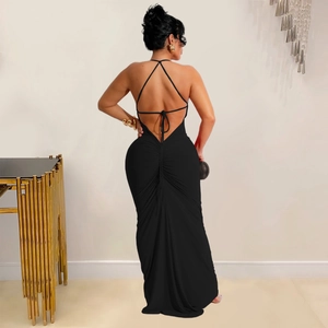 Close-up of the backless cross strap design and ruched details on a black maxi dress