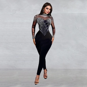 Close-up of mesh sleeves and bodice with intricate rhinestone geometric patterns