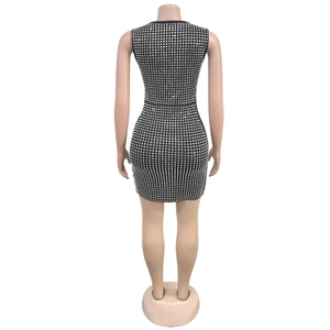 Rear view of tight black mini dress with sparkling silver rhinestone square patterns