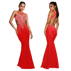 Detailed view of red mermaid evening dress with halter neck and sparkling rhinestone patterns