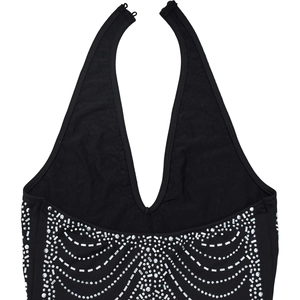 Detailed view of black halter dress with sparkling rhinestone geometric wave patterns