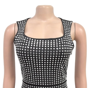 Close-up of black sleeveless dress featuring square silver rhinestones and a square neck