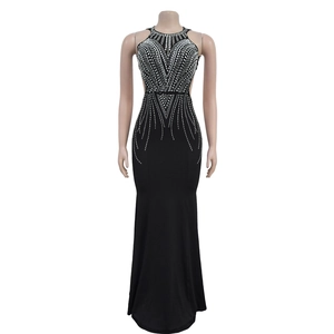 Detail of black halter evening dress showing silver rhinestone patterns and fish tail cut