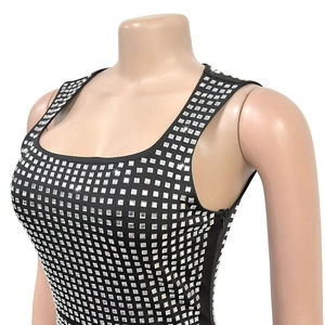 Detail of square silver rhinestones on a black bodycon dress with square neckline