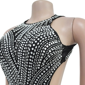 Detail of black backless dress with geometric rhinestones and halter neckline on mannequin