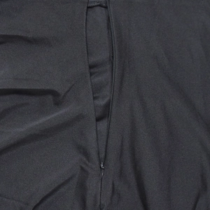 Macro view of hidden zipper on black slim fit dress with smooth fabric texture
