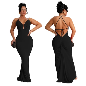 Macro detail of sexy backless black maxi dress featuring ruched fabric and crossover straps