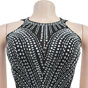 Detailed view of black halter dress with sparkling silver rhinestones and mesh V-neckline