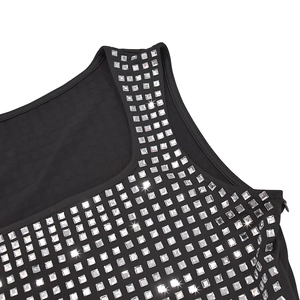 Detailed view of silver square rhinestones and invisible zipper on black evening dress