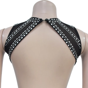 Detail of black backless halter dress featuring intricate silver rhinestone patterns