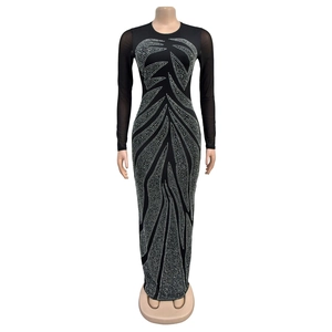 Close-up of sparkling silver rhinestones in wave patterns on a black bodycon dress