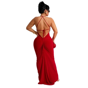 Detail of red backless dress featuring crisscross straps and elegant ruched detailing