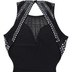 Detail of rhinestone embellishments and mesh patchwork on a black evening gown