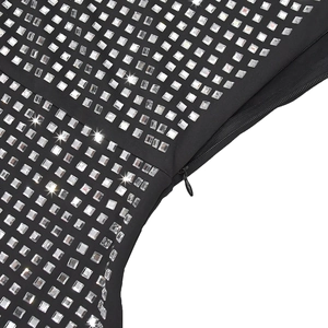 Macro detail of black evening dress featuring square rhinestones and hidden zipper