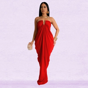 Detail of the plunging V-neck gold metal hardware and red pleated fabric of the dress