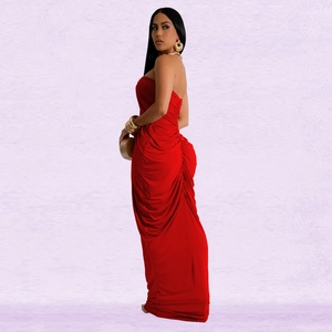 Detail of red off-shoulder maxi dress with elegant ruching and fishtail hemline