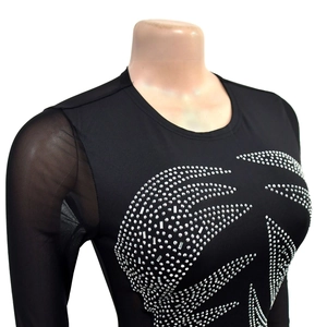 Detail of black long-sleeve dress featuring sparkling silver rhinestone flame patterns