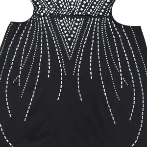 Detailed close-up of sparkling silver geometric rhinestones on a black fitted dress