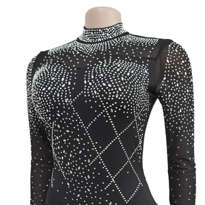 Close-up of sparkling silver rhinestones on sheer mesh black long sleeve jumpsuit