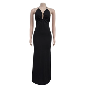 Close-up of sexy deep V-neckline with pleated details and metal ornament on black dress