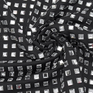 Macro detail of sparkling rhinestones on black bodycon evening dress fabric