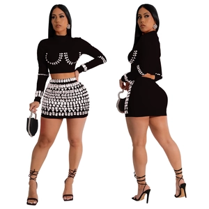 Detailed view of black two-piece set featuring silver rhinestones and long sleeves