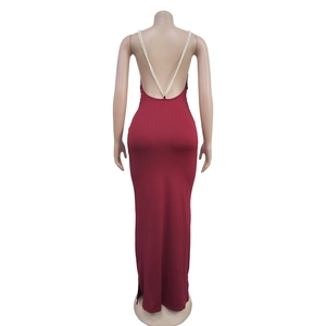 Close-up of a burgundy slim-fit maxi dress featuring an open back and white pearl straps