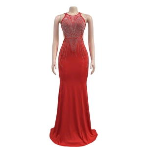 Detail of red fishtail evening dress featuring intricate rhinestone patterns and side cutouts