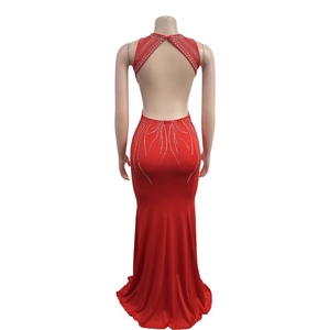 Detail view of red fishtail dress featuring open back design and sparkling silver rhinestones