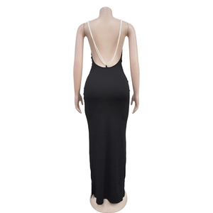 Detail of elegant backless black dress featuring luxury pearl V-shaped back straps