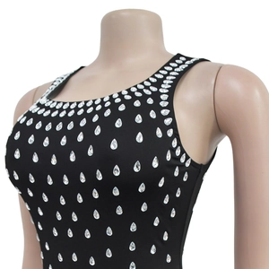 Detail of sparkling rhinestone embellishments on a black sleeveless bodycon dress