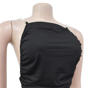 Detail view of black backless mini dress with elegant pearl straps and side ruching
