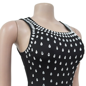 Close-up of teardrop rhinestones on black sleeveless dress with U-neckline detail
