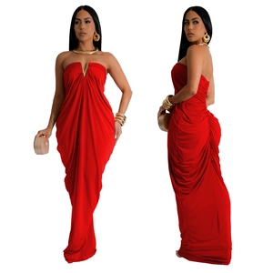 Close-up of the red strapless gown featuring a V-shaped metal accent and pleated details