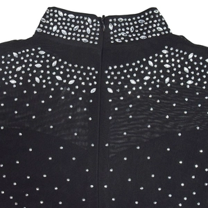 Detailed macro view of the high mock neck and sparkling rhinestones on mesh fabric
