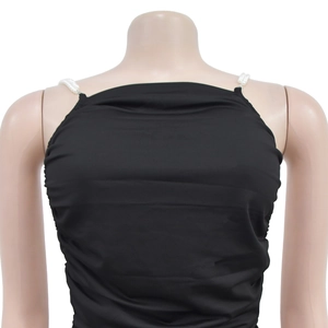 Detail of elegant black bodycon dress featuring pearl beaded straps on a female mannequin