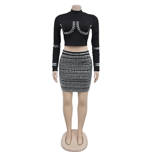 Detail of the shimmering silver rhinestone patterns on the black long sleeve two-piece set