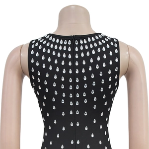 Detail view of rhinestone droplets on black sleeveless dress with invisible back zipper