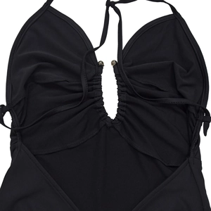 Detail of black V-neck dress featuring gathered chest design and decorative metal beads