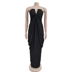Detail of the plunging V-neck with gold metal accent and pleated black evening dress