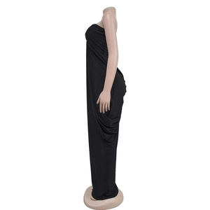 Side view detail of a form-fitting black strapless maxi dress with floor-length hem