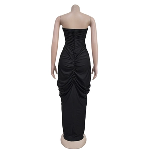 Detail of ruched back seam on a form-fitting black strapless evening maxi dress