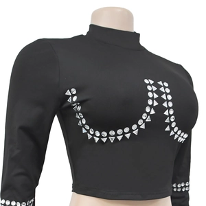 Detail of silver rhinestones on a black long sleeve crop top with geometric patterns