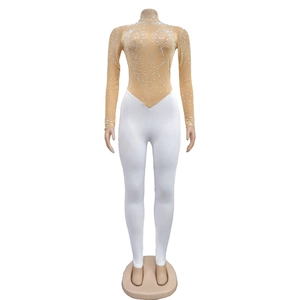 Macro view of mesh bodysuit detail with sparkling rhinestones and white fitted pants