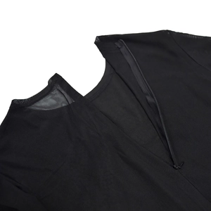 Detailed back view of a black mesh dress showing a fine zipper and smooth round neckline