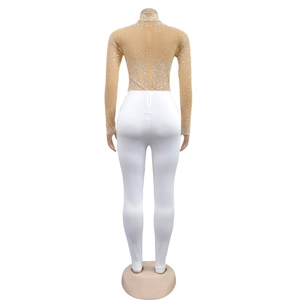Detail view of sheer mesh rhinestone top and white leggings from the back on a mannequin
