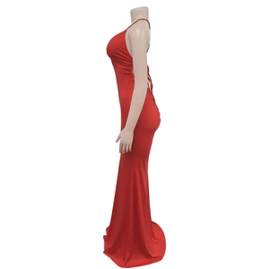 Detail of elegant red backless evening gown with a deep V-neck and mermaid tail hem