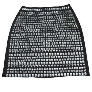 Detail of black mini skirt with geometric crystal rhinestones in various shapes